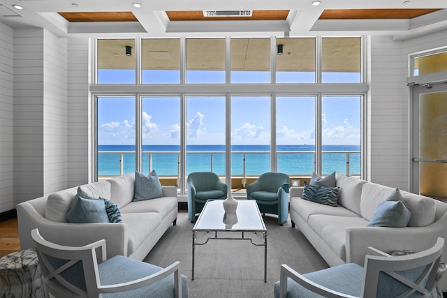 living room featuring a water view, wood walls, and hardwood / wood-style flooring