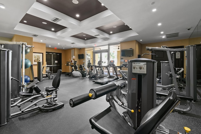 workout area with coffered ceiling