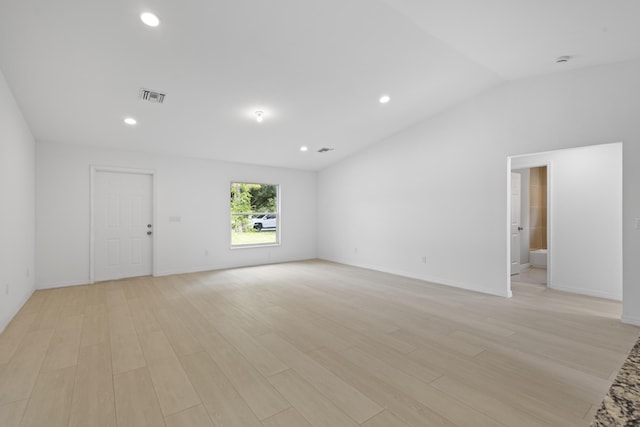 3848 NW 19th Ave, Okeechobee, FL 34972 - empty room featuring light wood-style flooring, vaulted ceiling, baseboards, and recessed lighting