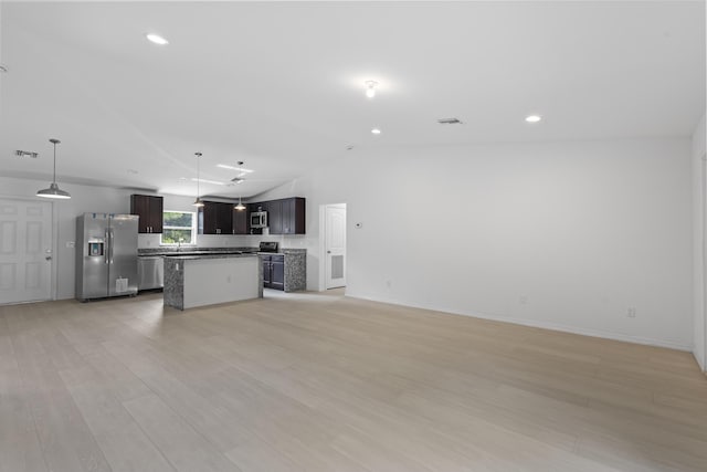 3848 NW 19th Ave, Okeechobee, FL 34972 - unfurnished living room with vaulted ceiling, light wood-style flooring, baseboards, a sink, and recessed lighting