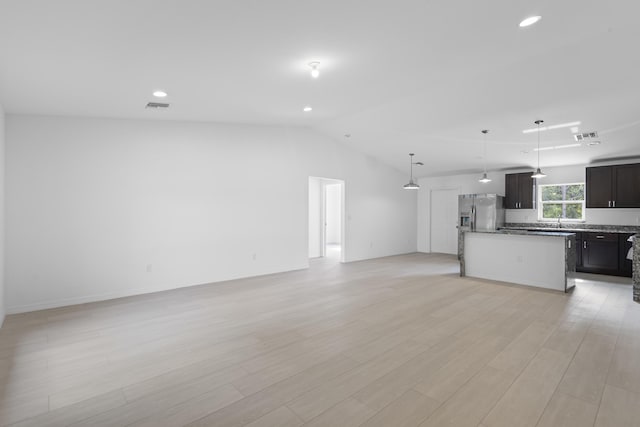 3848 NW 19th Ave, Okeechobee, FL 34972 - unfurnished living room featuring lofted ceiling, light wood-style floors, recessed lighting, a sink, and baseboards