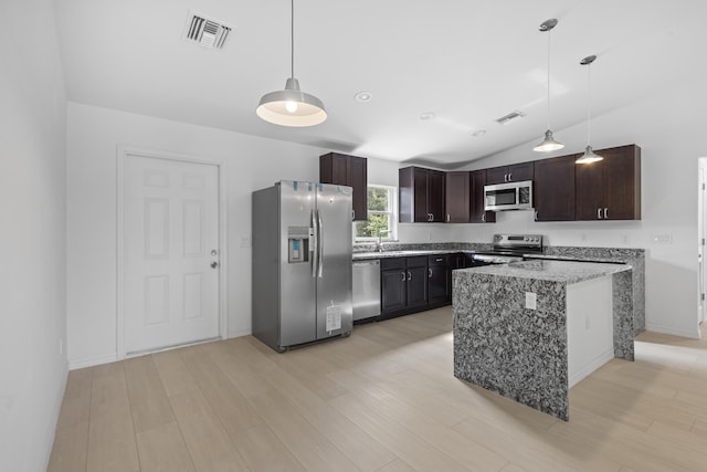 3848 NW 19th Ave, Okeechobee, FL 34972 - kitchen featuring appliances with stainless steel finishes, dark brown cabinetry, light stone countertops, light wood-type flooring, and lofted ceiling