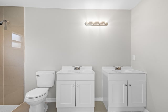 3848 NW 19th Ave, Okeechobee, FL 34972 - bathroom featuring vanity, toilet, tiled shower, and baseboards