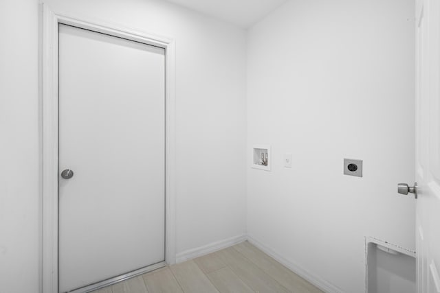 3848 NW 19th Ave, Okeechobee, FL 34972 - laundry area featuring hookup for an electric dryer, washer hookup, and baseboards