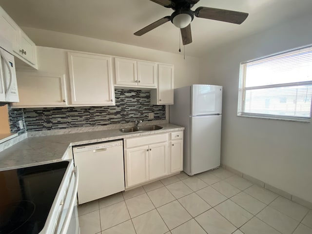 kitchen featuring sink, tasteful backsplash, white cabinets, white appliances, and ceiling fan