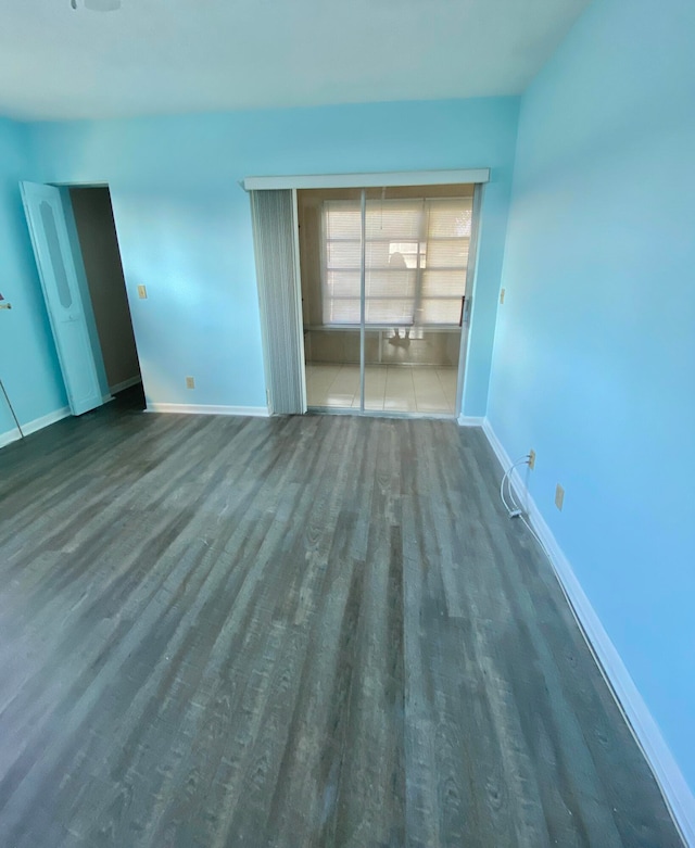 spare room featuring dark hardwood / wood-style flooring