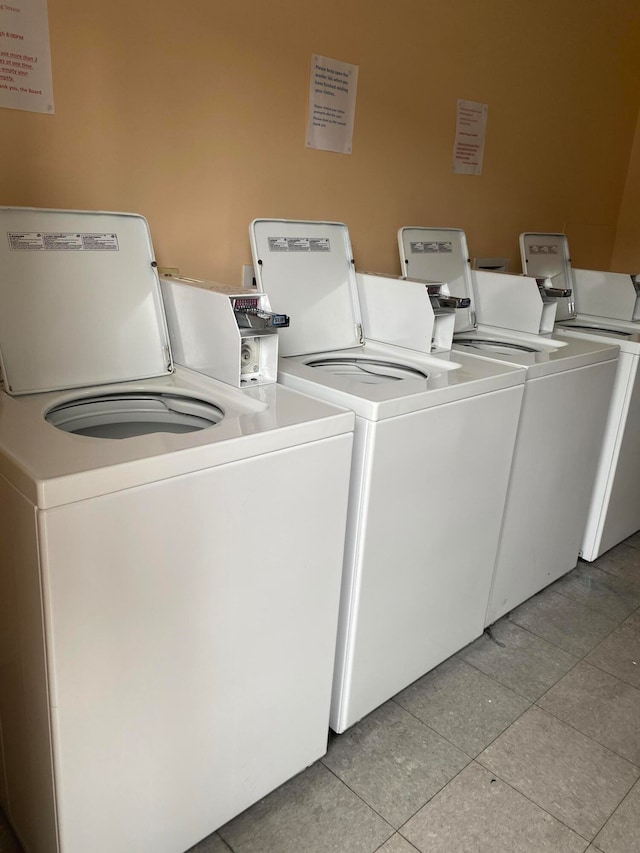 washroom featuring independent washer and dryer and light tile patterned flooring