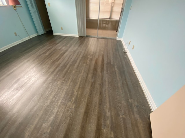 spare room featuring dark wood-type flooring