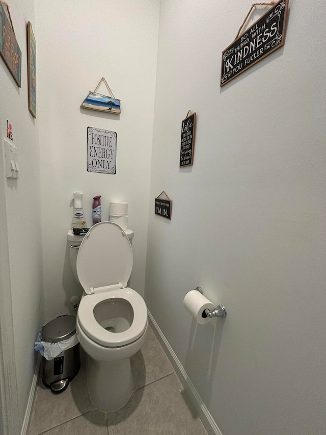 bathroom featuring toilet and tile patterned flooring