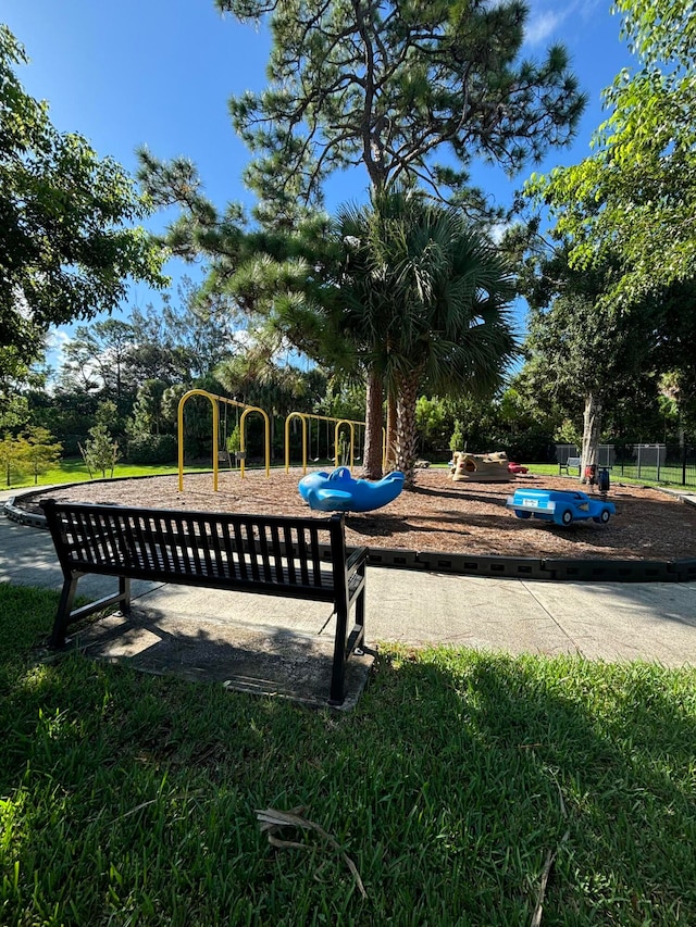 view of swimming pool featuring a playground and a yard