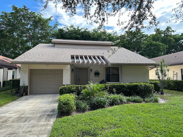 view of front of house with a front yard and a garage