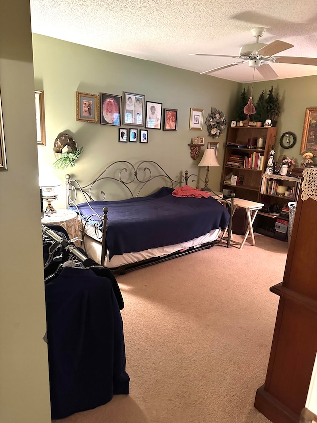 bedroom with carpet floors, a textured ceiling, and ceiling fan