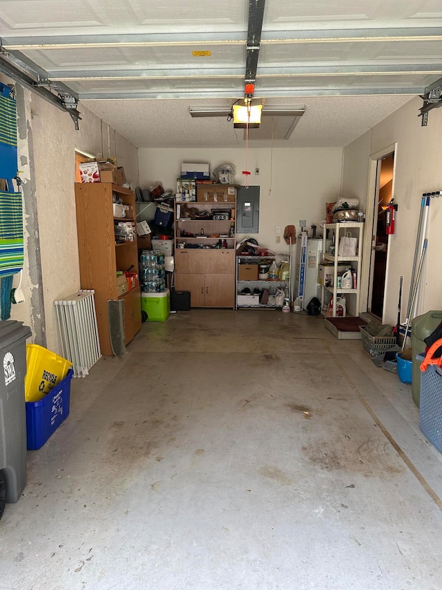 garage with a garage door opener and electric panel