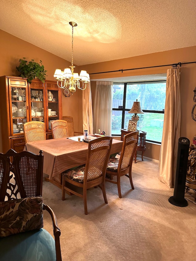 dining space featuring a textured ceiling, an inviting chandelier, and carpet flooring