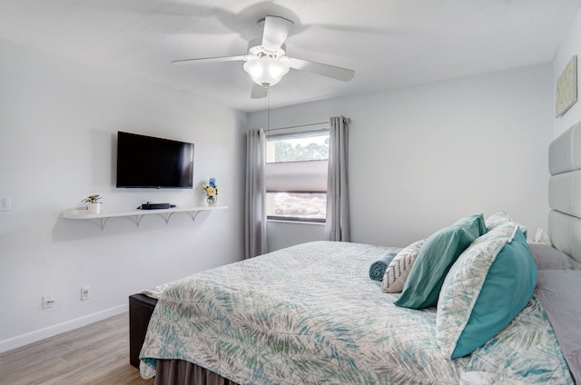 bedroom featuring light hardwood / wood-style floors and ceiling fan