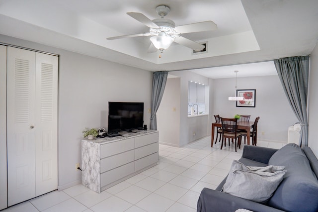 tiled living room with ceiling fan