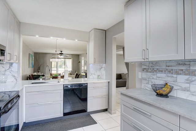 kitchen with white cabinets, sink, tasteful backsplash, and black appliances