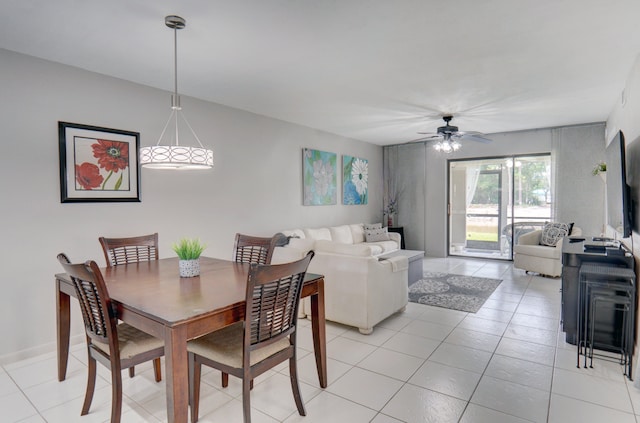 tiled dining space featuring ceiling fan