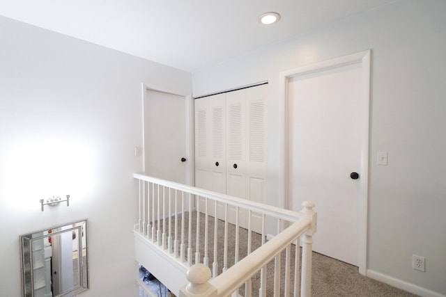 carpeted bedroom with a closet and a crib