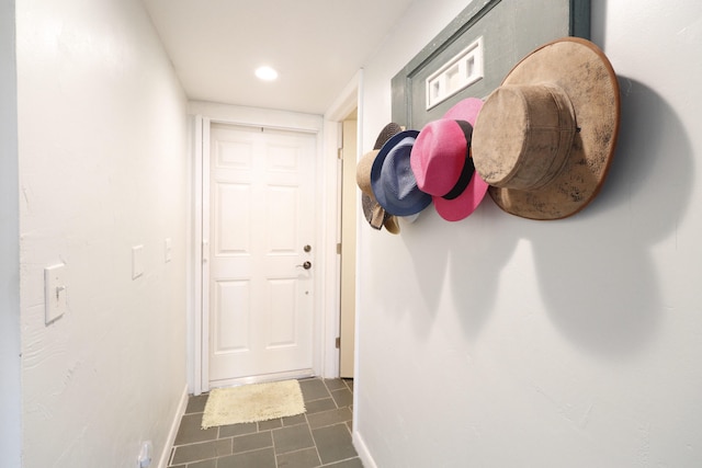 entryway featuring dark tile patterned floors