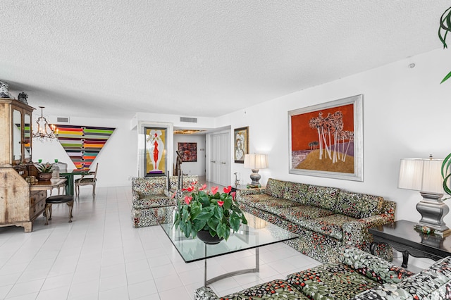 living room with a textured ceiling and a notable chandelier