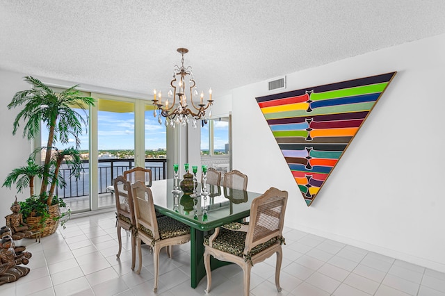 tiled dining space with a textured ceiling and a notable chandelier