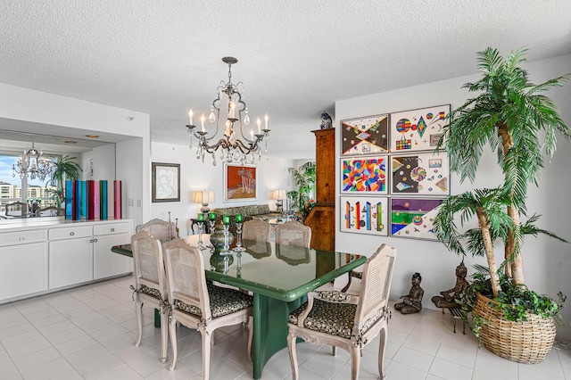 tiled dining room featuring a textured ceiling and an inviting chandelier