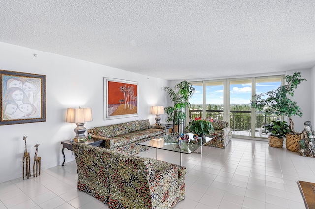 living room with a textured ceiling, light tile patterned floors, and expansive windows