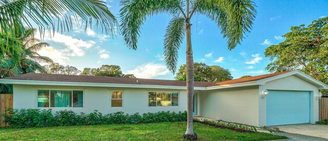 8045 W Lake Dr, Lake Clarke Shores, FL 33406 - ranch-style home featuring stucco siding, a garage, and concrete driveway