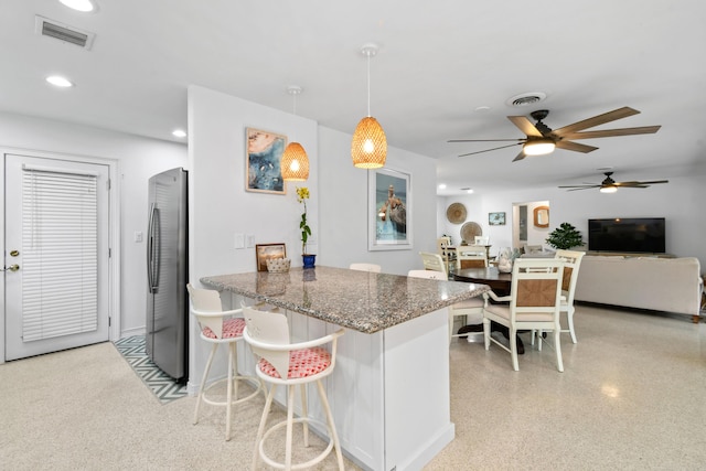 8045 W Lake Dr, Lake Clarke Shores, FL 33406 - kitchen featuring freestanding refrigerator, ceiling fan, dark stone countertops, recessed lighting, and dark aggregate flooring