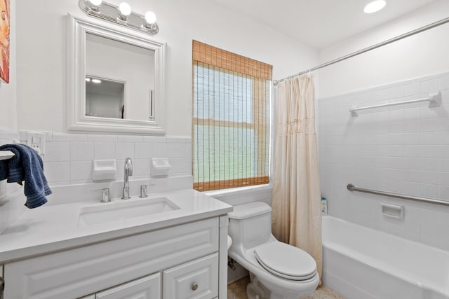 8045 W Lake Dr, Lake Clarke Shores, FL 33406 - full bathroom with tile walls, toilet, shower / tub combo with curtain, vanity, and a wainscoted wall