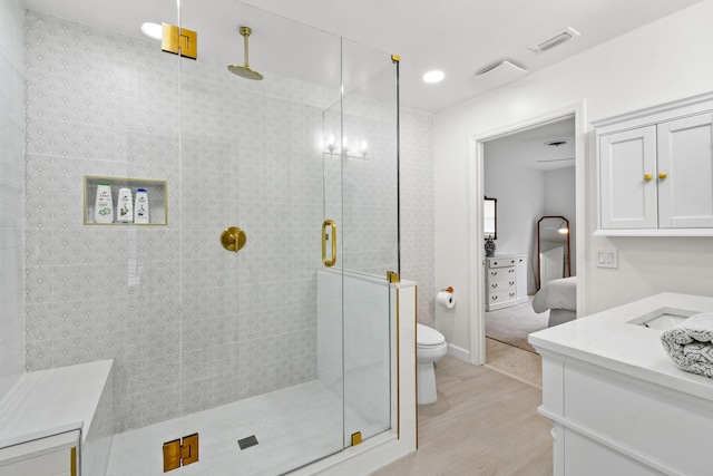 8045 W Lake Dr, Lake Clarke Shores, FL 33406 - ensuite bathroom with a stall shower, toilet, wood finished floors, and vanity