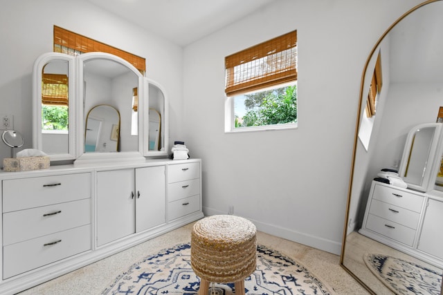 8045 W Lake Dr, Lake Clarke Shores, FL 33406 - bathroom with speckle patterned floor, plenty of natural light, baseboards, and vanity