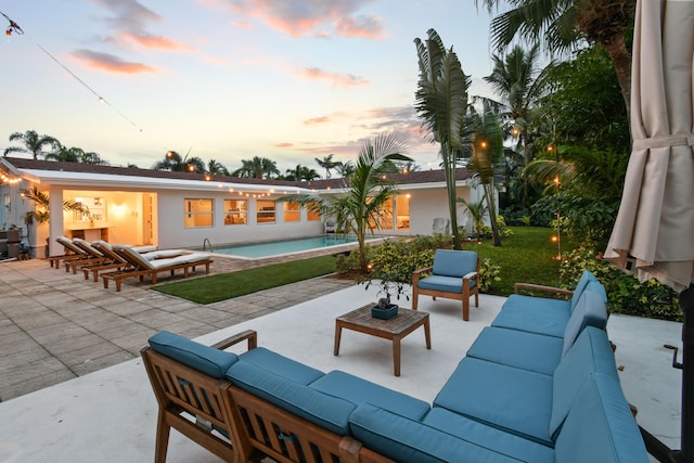8045 W Lake Dr, Lake Clarke Shores, FL 33406 - patio terrace at dusk featuring outdoor lounge area and an outdoor pool