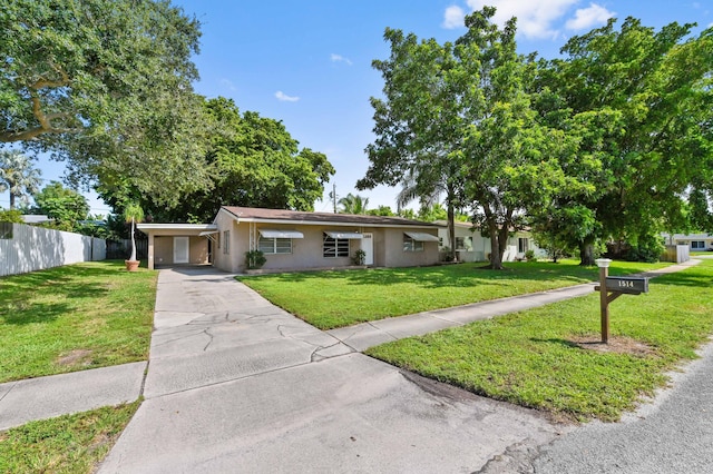 single story home with a front yard and a carport