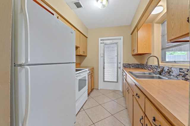 kitchen with light brown cabinetry, tasteful backsplash, white appliances, sink, and light tile patterned floors