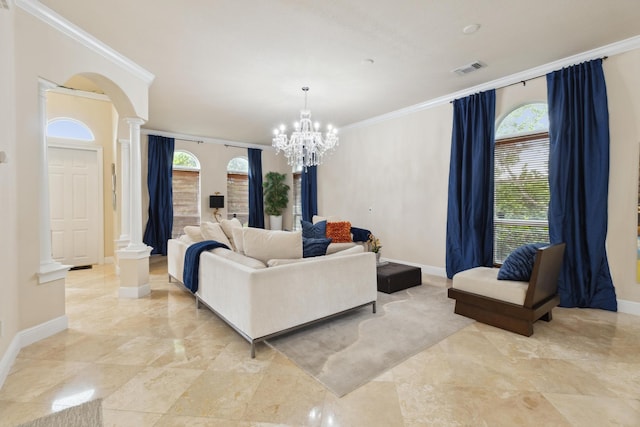 living room featuring crown molding, decorative columns, and a notable chandelier