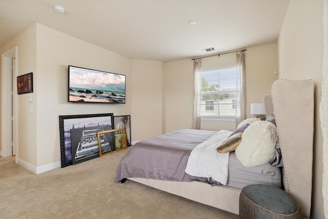 bedroom featuring light carpet