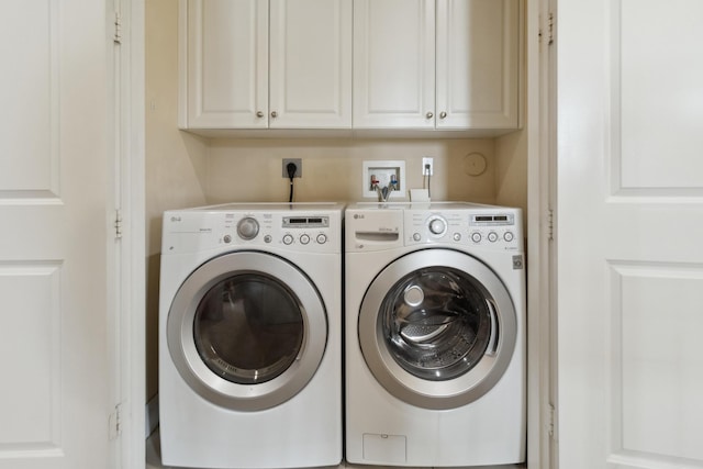 laundry area with cabinets and washing machine and clothes dryer