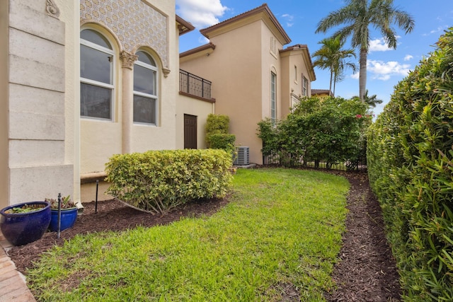 view of yard featuring a balcony and central AC