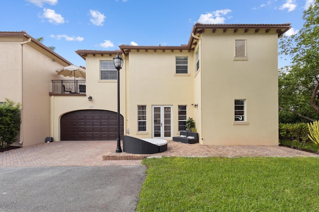 exterior space with a patio, a garage, and a front yard