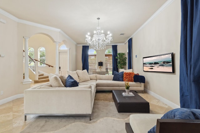 living room with a healthy amount of sunlight, decorative columns, ornamental molding, and an inviting chandelier