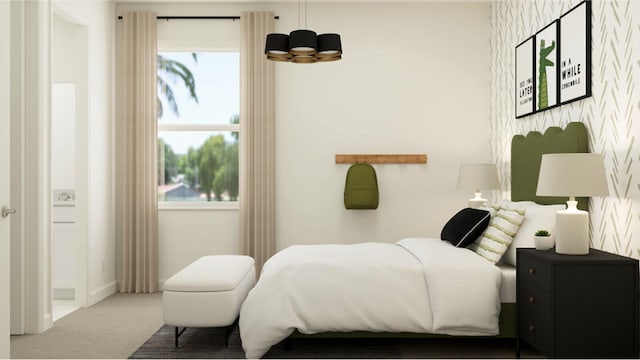 bedroom featuring carpet flooring and a notable chandelier