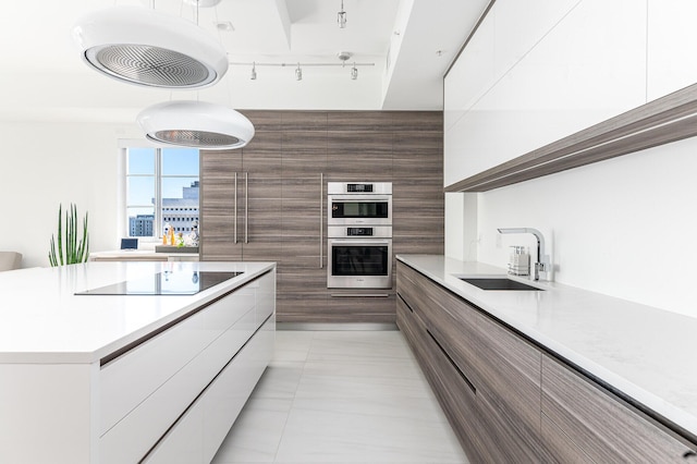 kitchen with sink, light tile patterned floors, white cabinets, black electric cooktop, and stainless steel double oven