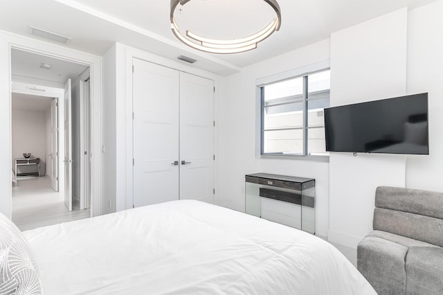 bedroom with a closet and visible vents