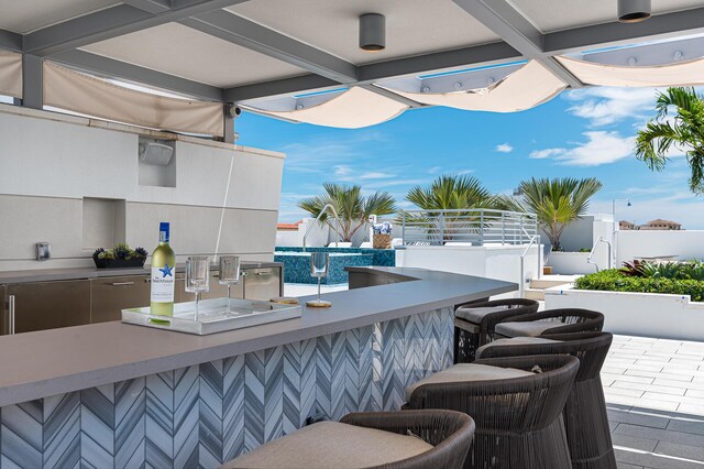 view of swimming pool featuring a patio area and a hot tub