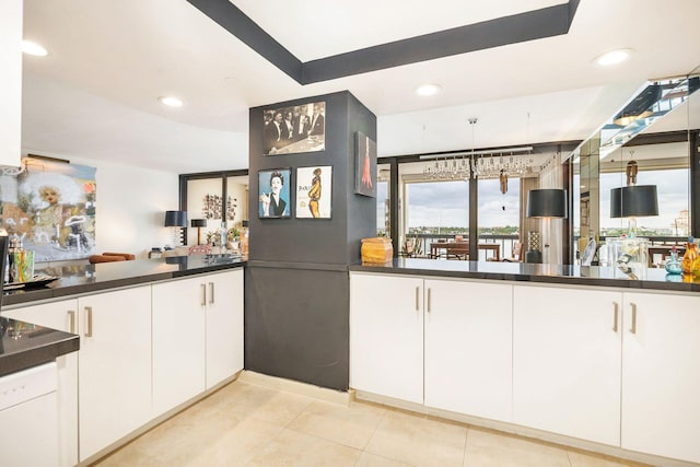 kitchen with light tile patterned floors and white cabinets