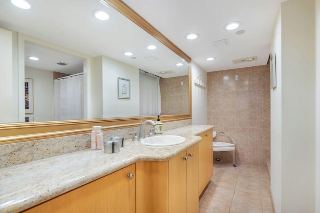 bathroom featuring tile walls, tile patterned flooring, curtained shower, vanity, and toilet