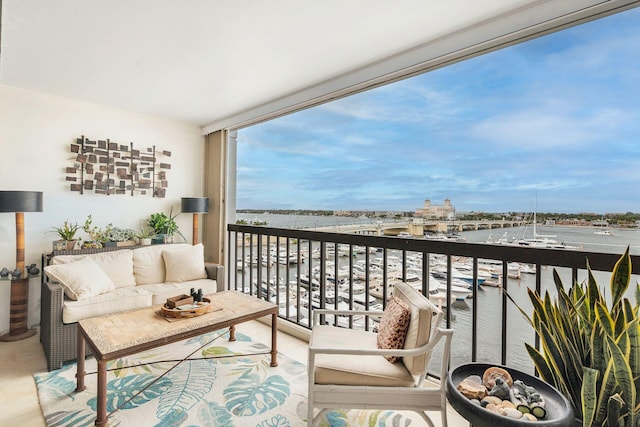 balcony featuring an outdoor living space and a water view