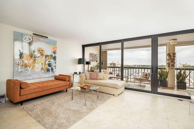 tiled living room featuring floor to ceiling windows